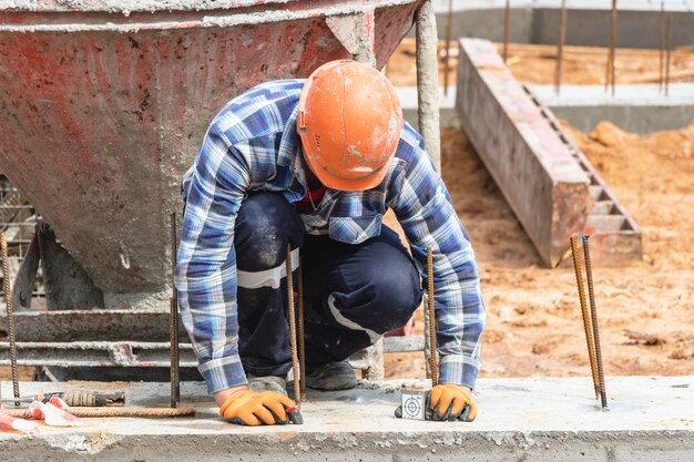 Photo construction of a residential area geodetic stakeout surveyor at a large construction site a man with a tachometer during work makshader