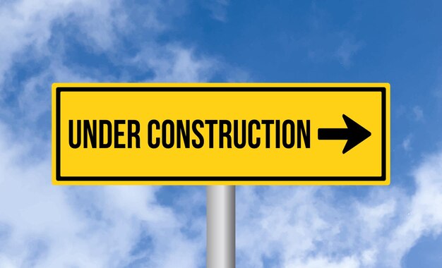 Photo under construction road sign on cloudy sky background