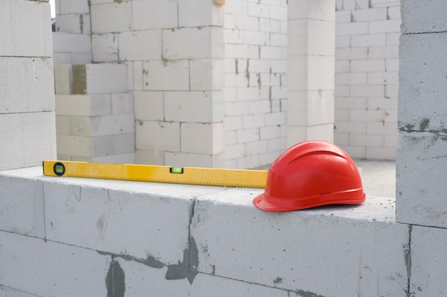 Photo construction safety helmet and construction level at the construction site