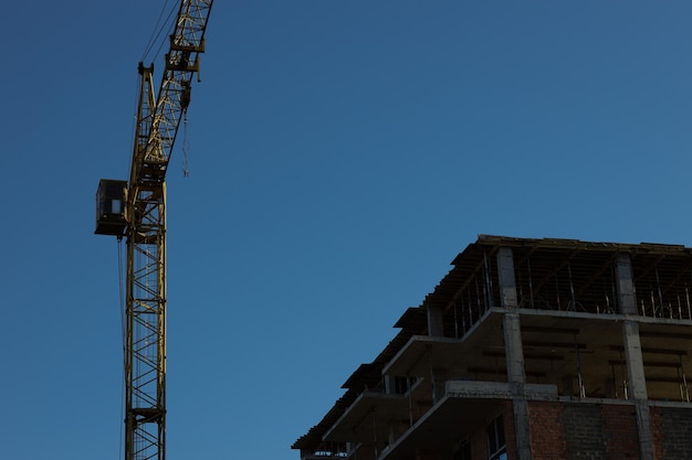 Construction site background hoisting cranes and new buildings\
industrial background