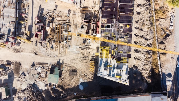 Construction site, buildings with cranes.