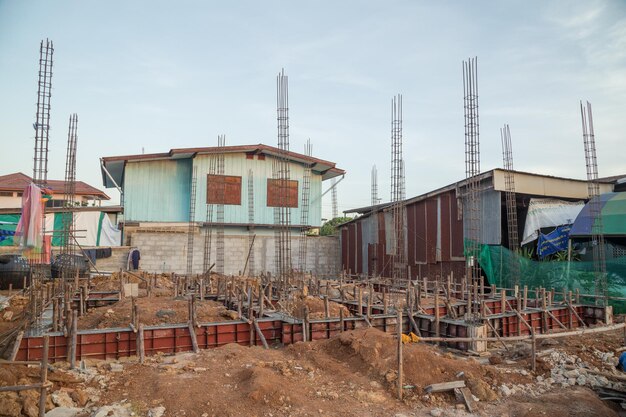 Construction site by buildings in city against sky