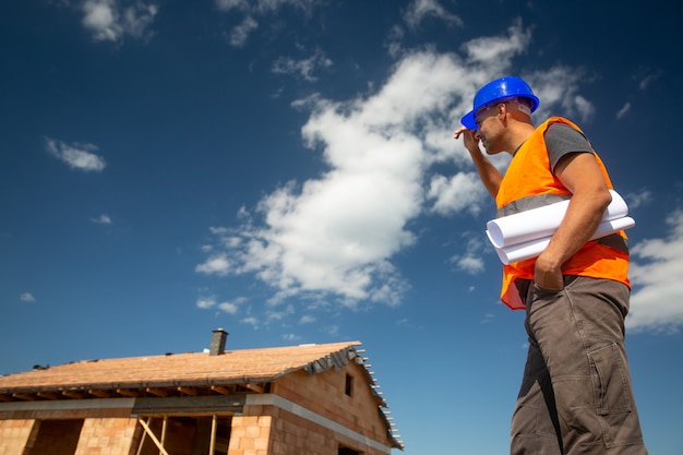 Construction or site manager overseeing the construction of the new building with a construction project, concept development