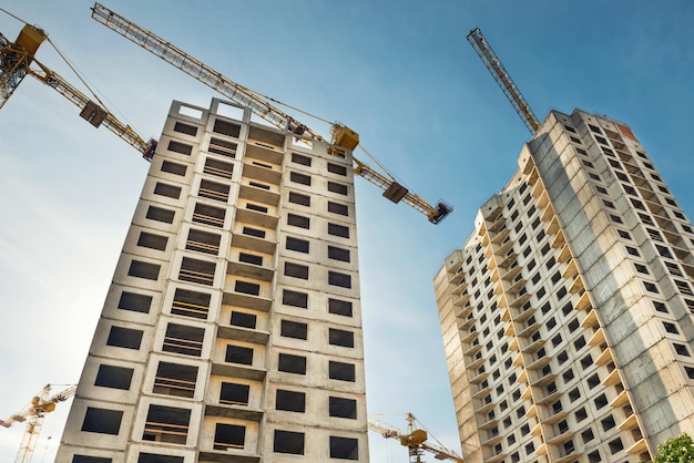 Construction site with buildings and industrial cranes