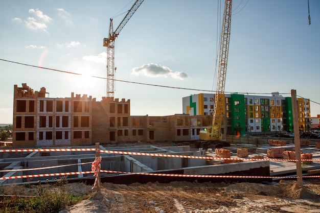 Construction site with cranes against the background of new buildings