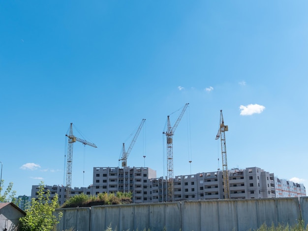 Construction site with many cranes against the sky