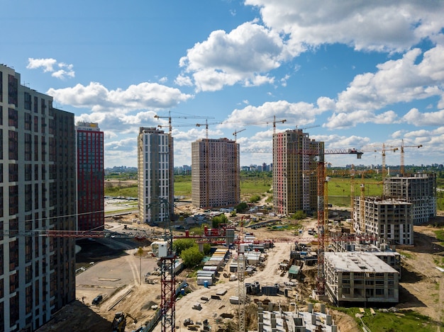 Construction site with multistorey buildings tower cranes and construction equipment