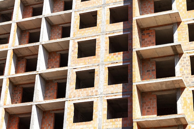 Construction site with unfinished highrise apartment building