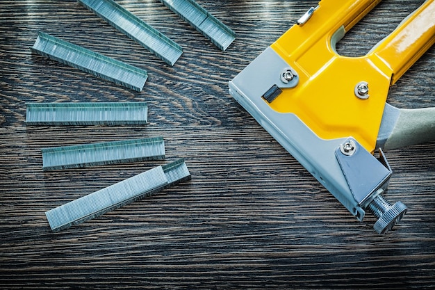 Construction stapler staples on wooden board