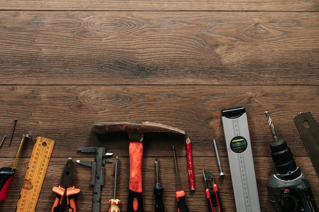 A construction tool on a brown wooden . View from above. Picture , screensaver.  construction, repair, construction, production, . copyspace.