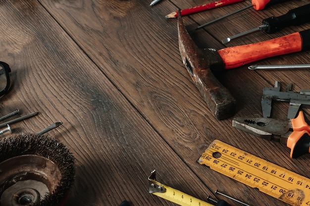 Photo a construction tool on a brown wooden . view from above. picture , screensaver.  construction, repair, construction, production, . copyspace.