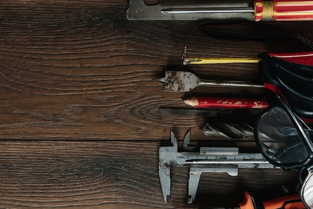 A construction tool on a brown wooden . View from above. Picture , screensaver.  construction, repair, construction, production, . copyspace.