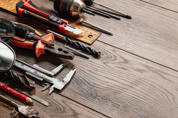 A construction tool on a brown wooden . View from above. Picture , screensaver.  construction, repair, construction, production, . copyspace.