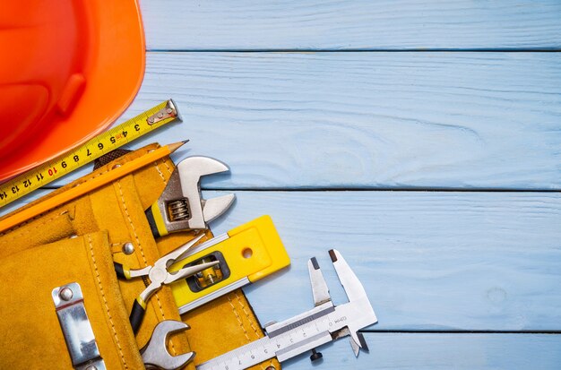 Construction tool kit for a builder in a bag on blue wooden boards also place for advertising