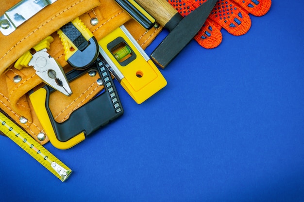 Construction tools in a bag and work gloves