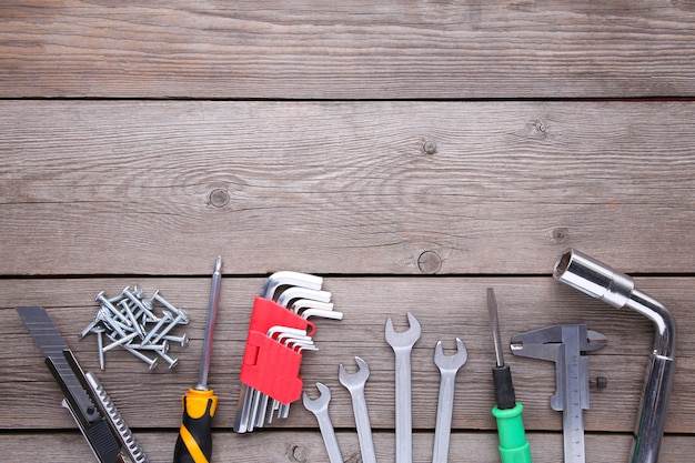 Construction tools on a grey wooden desk, copy space