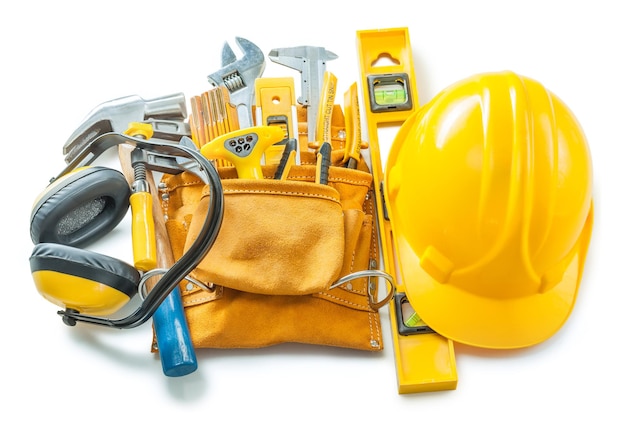 Construction tools isolated on white helmet toolbelt earphones and other