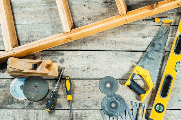 Construction tools for repairing on old wooden background