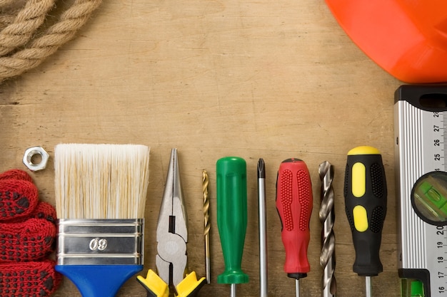 Construction tools on wood background texture