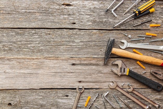 Construction tools on wooden background with copy space