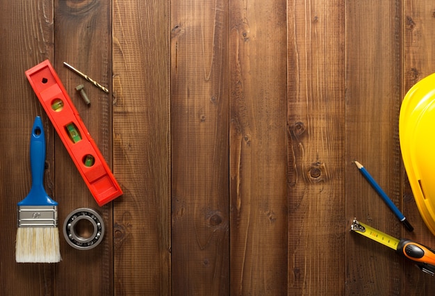 Construction tools on wooden background