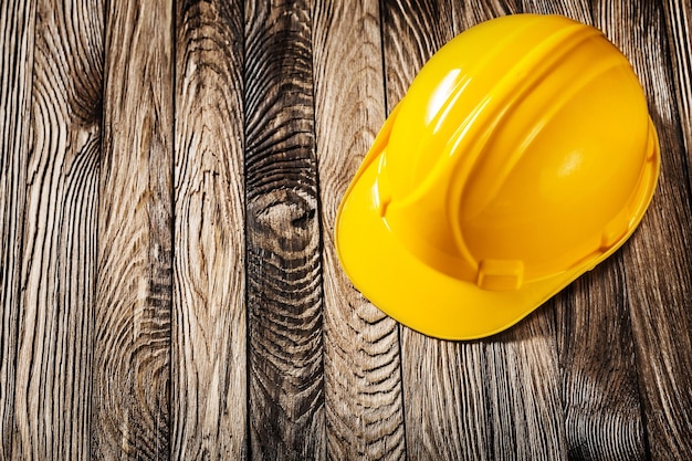 construction tools yellow helmet  on vintage wooden boards
