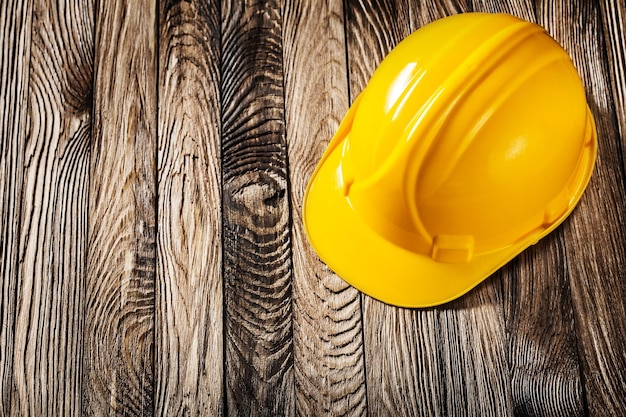 Construction tools yellow helmet  on vintage wooden boards