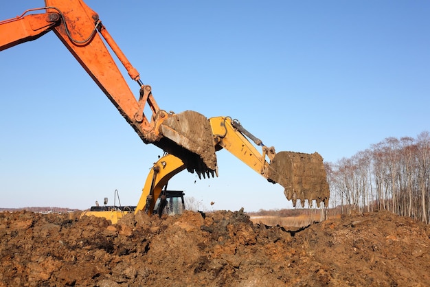 Construction Two Excavators work in dirt