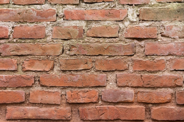 Construction of wall with texture of very old red bricks