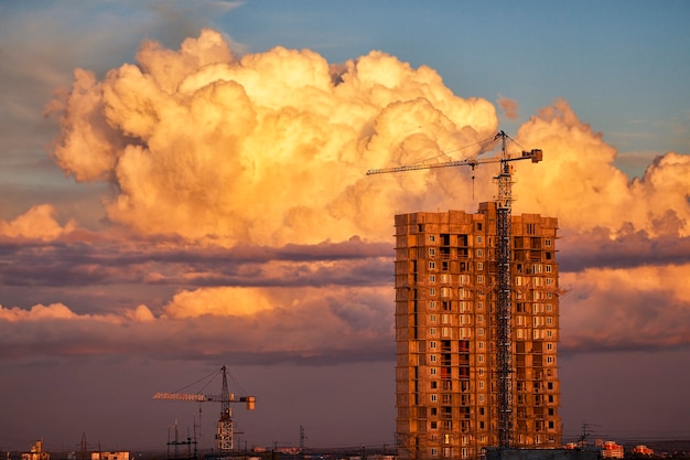 Construction with dramatic evening light and big cloud on the background