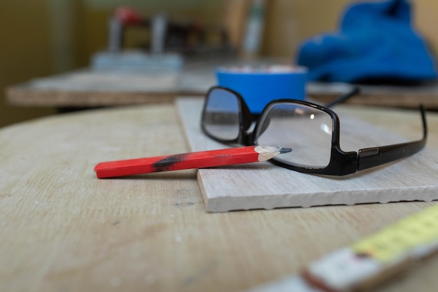 During construction work various tools necessary for the work are on the table The glasses are lying on the table