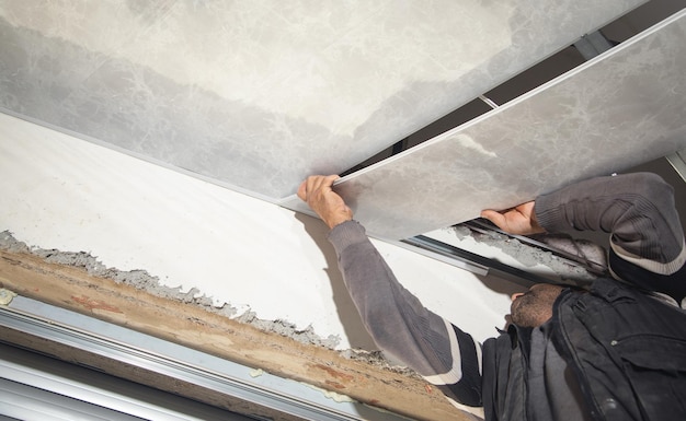 Construction worker assemble a suspended ceiling