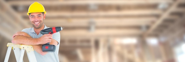 Construction Worker on building site holding drill up ladder