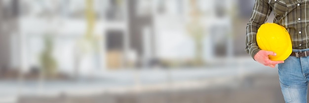 Photo construction worker on building site holding helmet