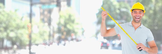 Construction Worker on building site holding measuring tape