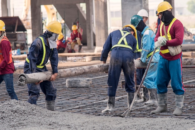 Construction worker Concrete pouring during commercial concreting floors