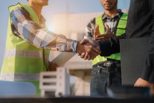 Construction worker and contractor Client shaking hands with team builder in renovation site in the morning