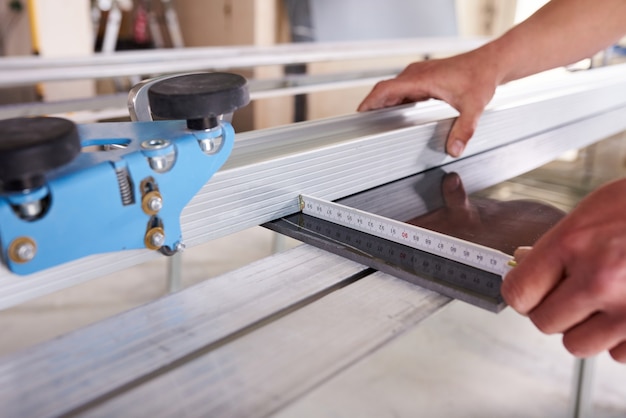 Construction worker cutting ceramic tiles using ceramic cutter