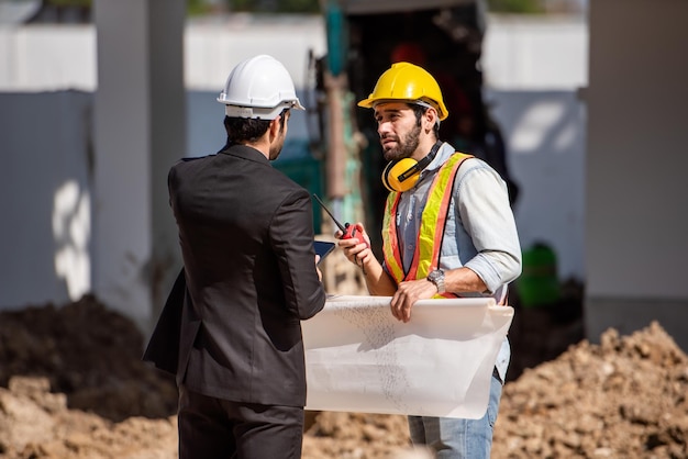Construction worker and engineer working together on construction site
