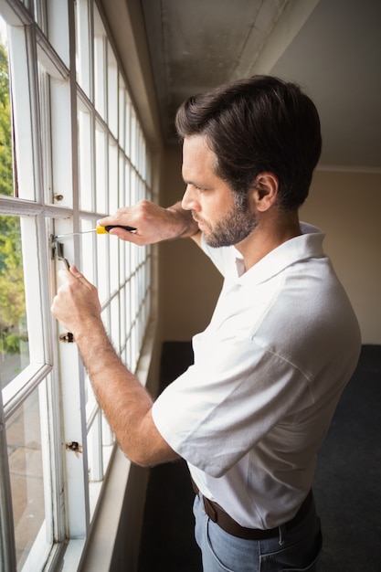 Construction worker fixing the window