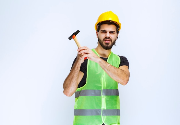 Construction worker holding a claw hammer .