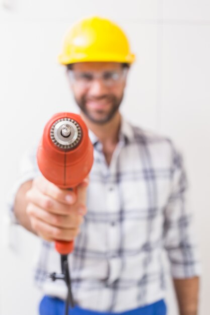 Construction worker holding power drill