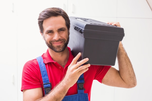 Construction worker holding tool box