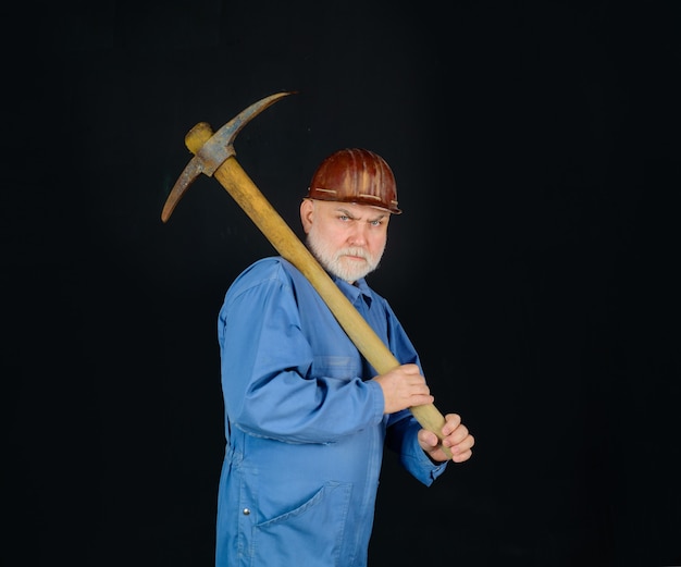 Construction worker holds pickaxe man contractor with axe smiling workman with pickaxe construction