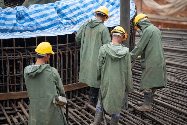 Construction worker pouring a concrete at mass foundation 