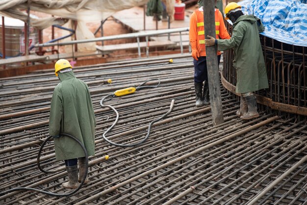 Construction worker pouring a concrete at mass foundation 