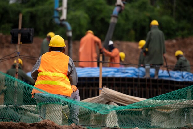 Construction worker pouring a concrete at mass foundation 