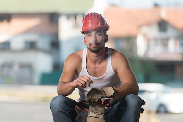 Construction worker relaxing the fresh air during work