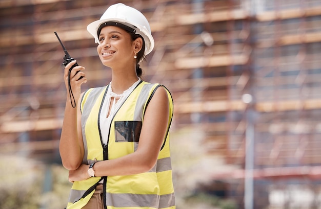 Construction worker smile and radio with woman for communication in logistics engineering and safety Leadership planning and inspection with employee working on project management development