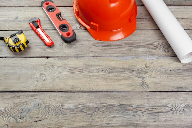 Construction  worker supplies and instruments on wooden table background